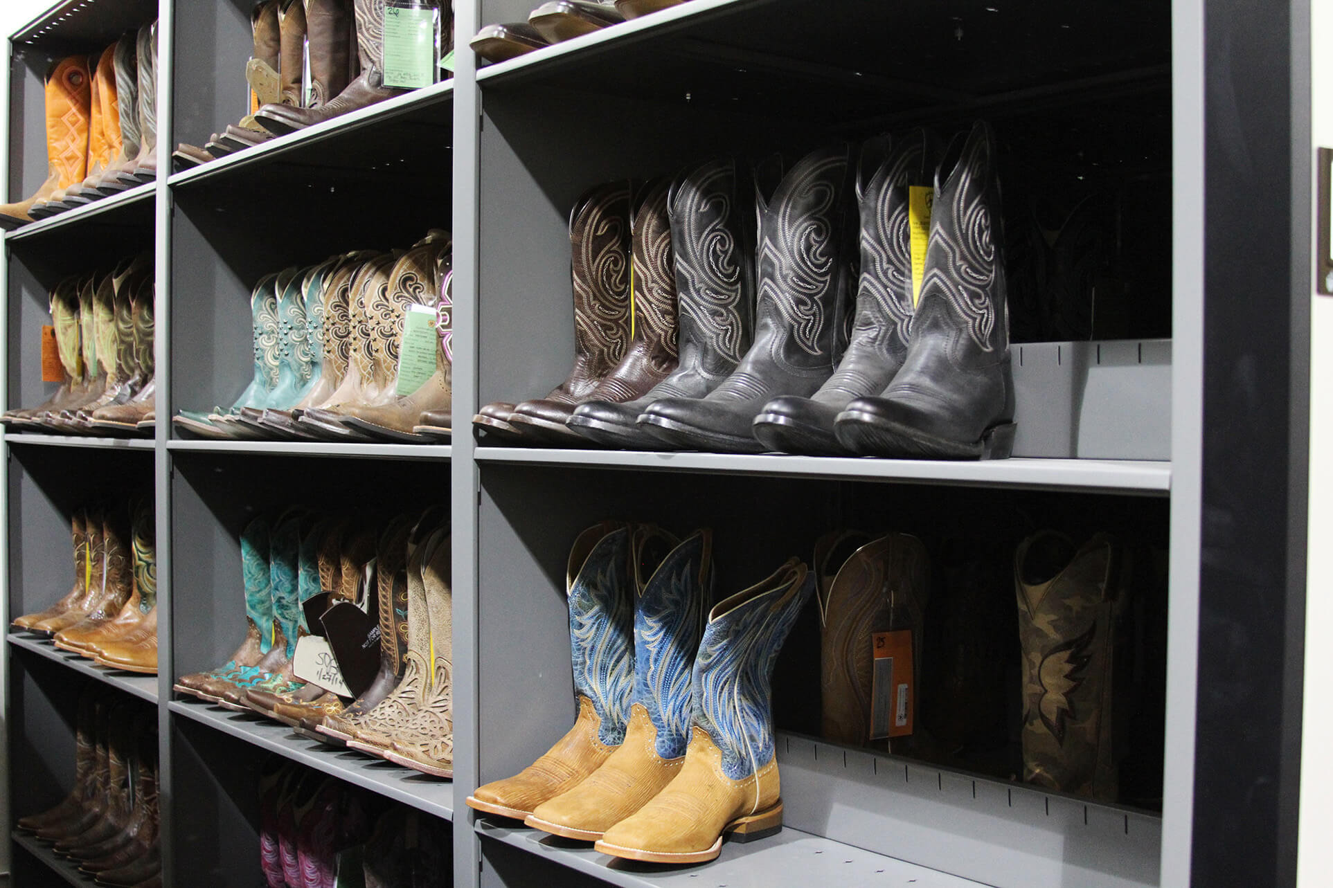 Cowboy Boot storage on static shelving of current and past boot designs