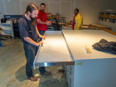 Spacesaver Storage Solutions techs installing a museum archival flat file 423