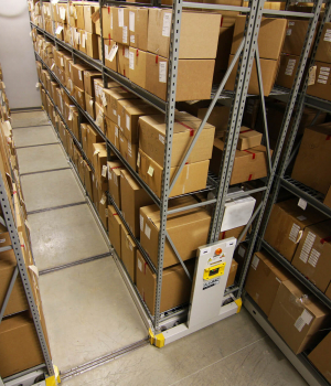 Boxed storage on high-density mobile system with wide span shelving